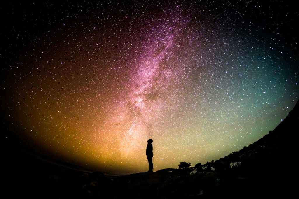 silhouette of a man observing the starry sky