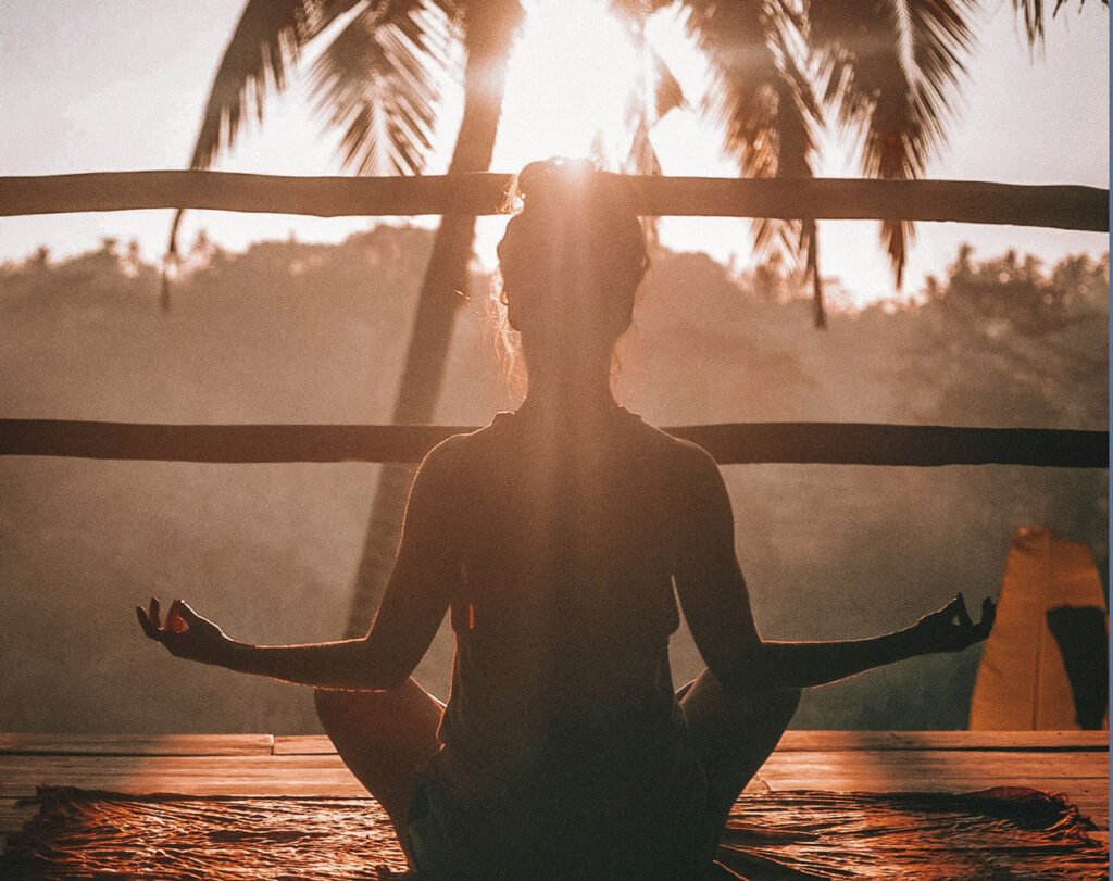 woman meditating at sunset.