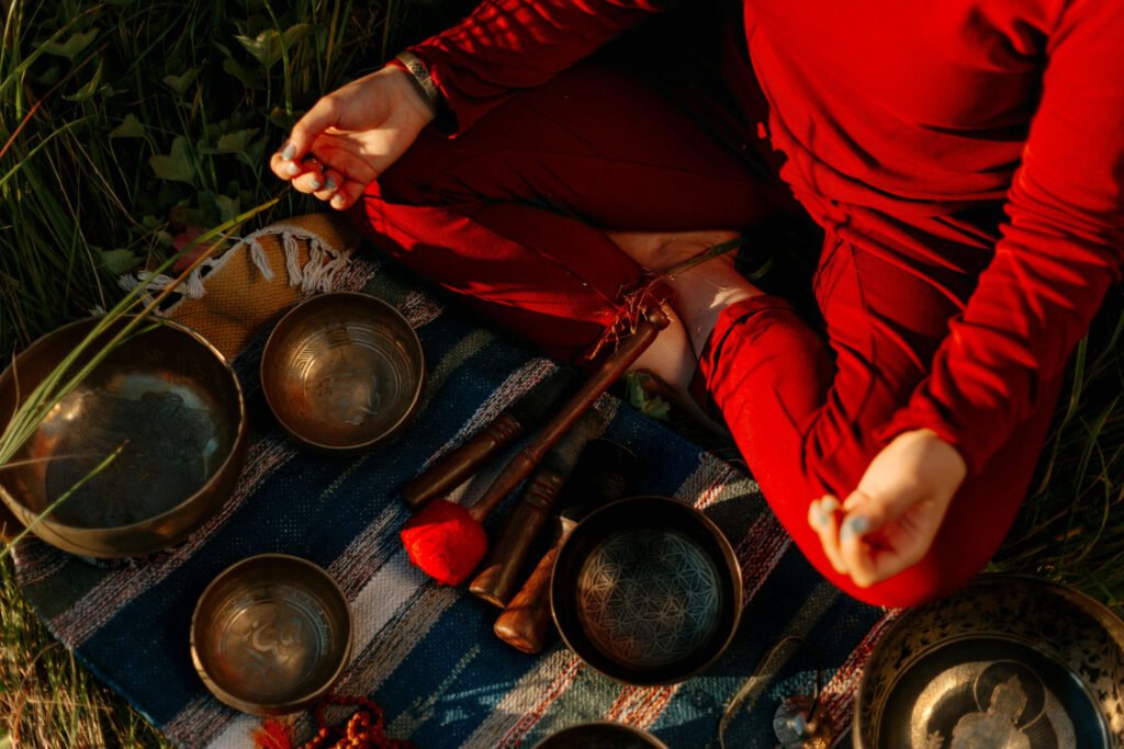 person meditating with tibetan bowls. Third eye chakra