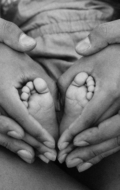 hands hugging baby feet