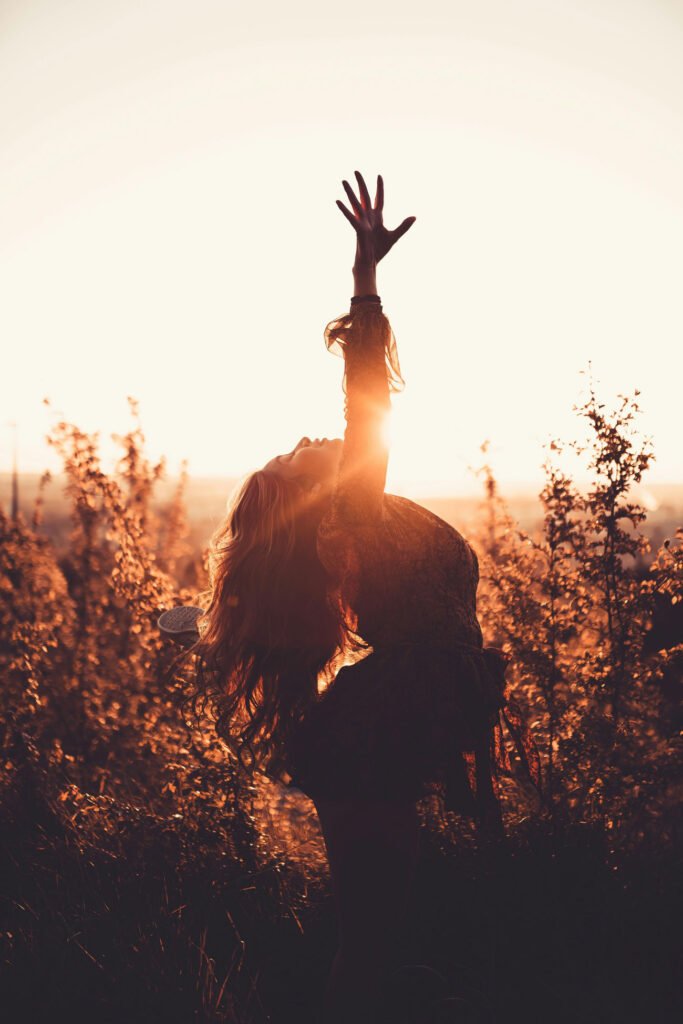 woman stretching at sunset