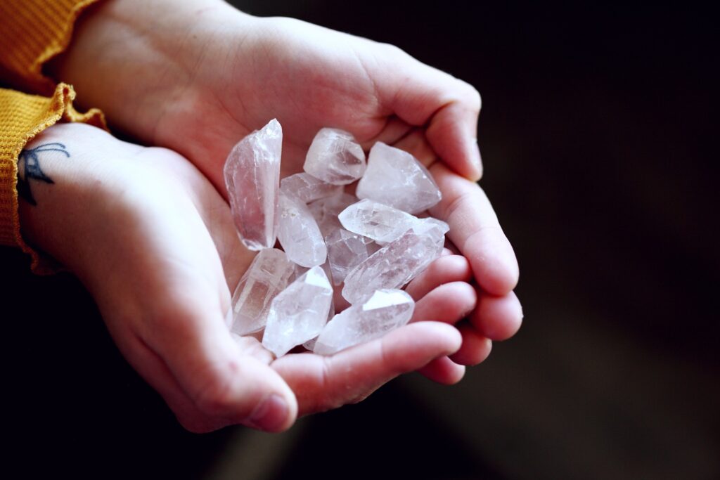 hands with quartz crystals